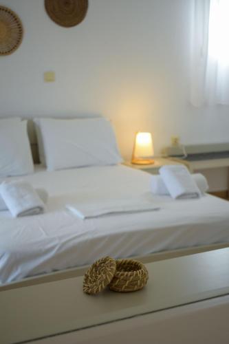 a white bed with a rope on top of it at Villa Maniati Studios in ayios Petros