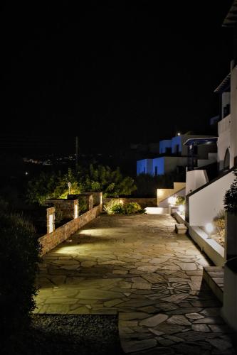 a night view of a stone walkway at Villa Maniati Studios in ayios Petros