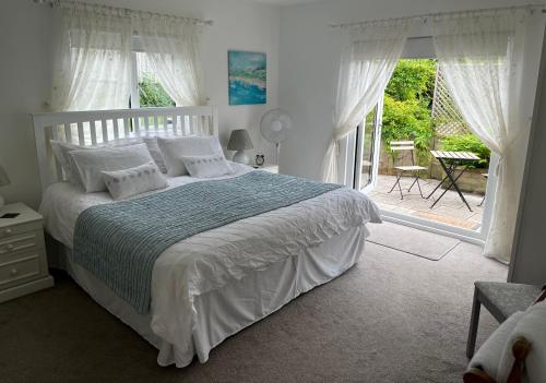 a bedroom with a bed and a large window at Lissett Lodge in Battle