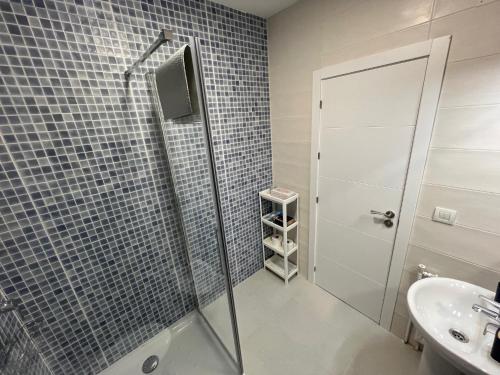 a bathroom with a shower and a sink at Piso Camino de Santiago in Sarria