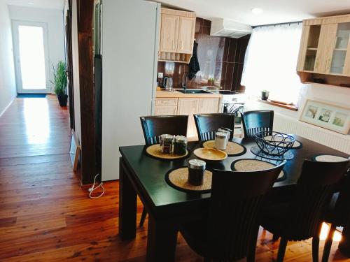 a kitchen with a black table and chairs in a room at Penzion Václav in Hnojní