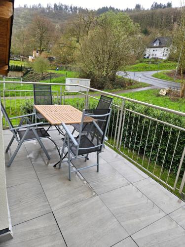a wooden table and two chairs on a balcony at Haus Kleeblatt in Cochem