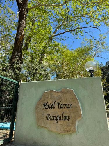 a sign that reads hotel yuri jungatown on a wall at Hotel Yavuz Bungalow in Cıralı