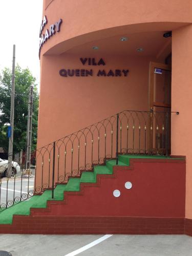 a building with a staircase in front of a store at Vila Queen Mary in Constanţa