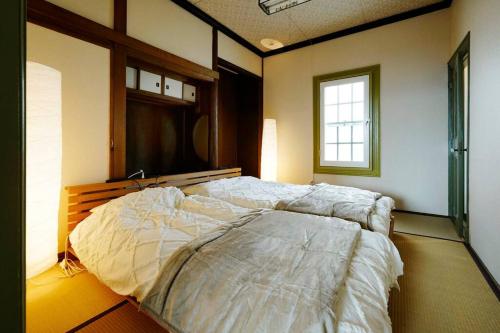 Säng eller sängar i ett rum på 1日1組限定 北海道最古の写真館 無料駐車場