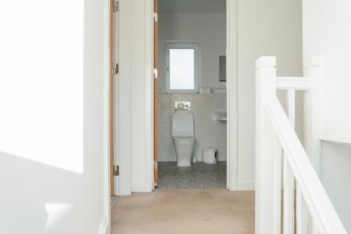 a bathroom with a toilet in a room at Lovely House Central Birmingham in Birmingham
