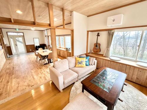 a living room with a couch and a table at La Assayaca Nasu in Nasu-yumoto