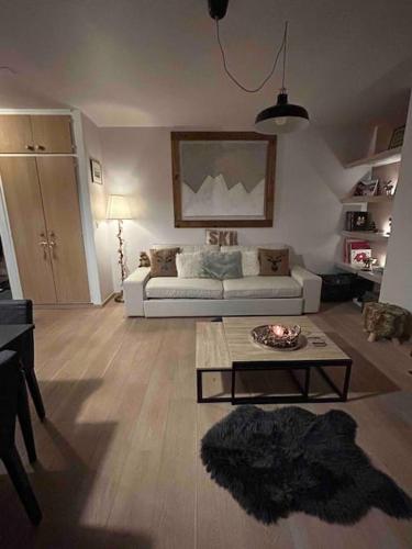 a living room with a couch and a coffee table at A 2 min. à pied du centre de Crans et des remontée in Lens