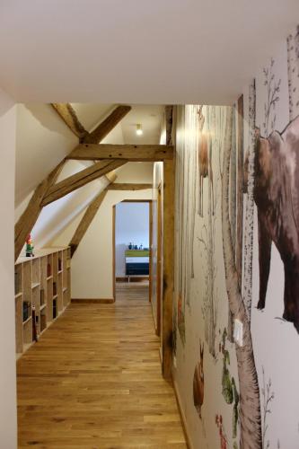 a hallway in a house with a horse mural on the wall at Le Domaine du Château in Varennes-lès-Narcy