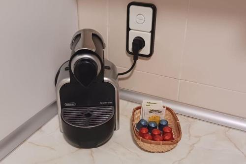 a toaster plugged into a wall next to a basket of candy at Apartamento Turístico Zaragoza in Zaragoza