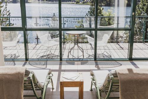 a room with chairs and a table and a large window at Seehotel Jägerwirt in Turracher Hohe