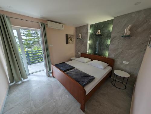 um pequeno quarto com uma cama e uma janela em Apartments Klenovica Jadranka Čačić em Klenovica