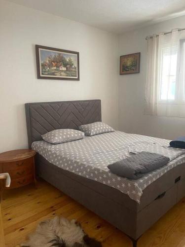a bedroom with a bed in a room at Kadmi in Njeguši
