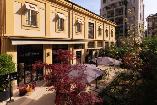 a yellow building with flowers in front of it at Vmaison Brera Milano in Milan