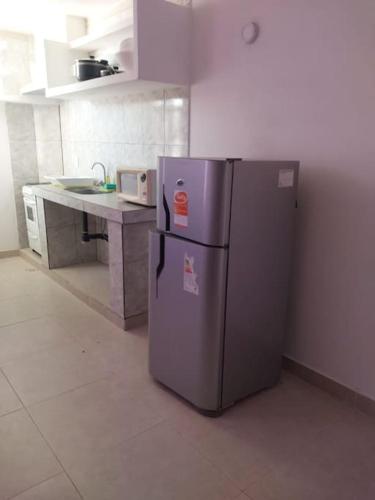 a kitchen with a stainless steel refrigerator in a room at Departamento en San Carlos in San Carlos