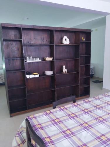 a bedroom with a large wooden book shelf at Departamento en San Carlos in San Carlos