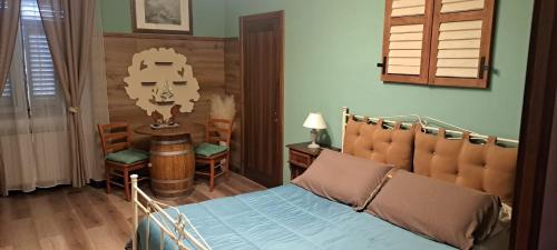 a bedroom with a bed and a table and chairs at B&B Empire 1970 in Trieste