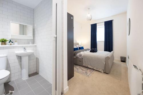 a white bathroom with a bed and a sink at City Centre - Luxe 2Bed Palazzo in Manchester