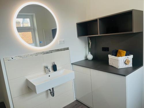 a white bathroom with a sink and a mirror at HarzFokus - Beautynest - #Netflix#Wlan#Sauna#Zentrum in Wernigerode