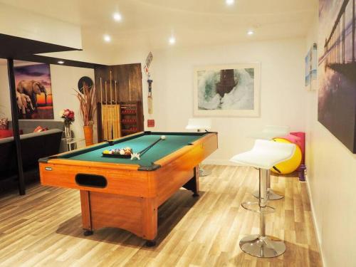 a room with a pool table and a stool at LOVE and Relax at Dream Catcher Retreat in Whitby