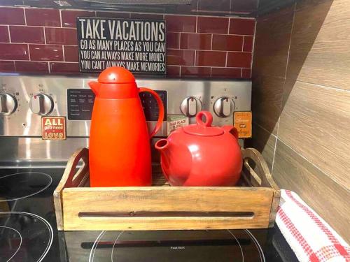 a wooden tray with a pitcher and a tea kettle at LOVE and Relax at Dream Catcher Retreat in Whitby