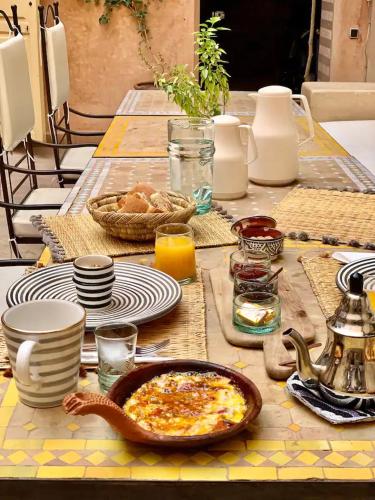 a table with a plate of food on it at Riad Siena II in Marrakech