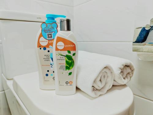 two bottles of cleaner sitting on a toilet in a bathroom at Central Park 5min Angsana Mall JCHome By MWM in Johor Bahru