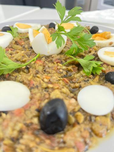 a plate of food with eggs and plants on it at Maison des Oliviers, Yasmine Hammamet, Bouficha in Hammamet Sud