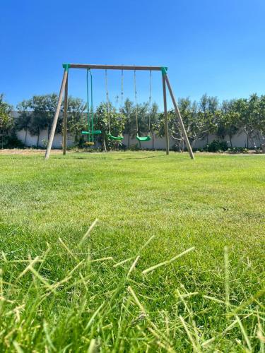 a swing set in a field of grass at Maison des Oliviers, Yasmine Hammamet, Bouficha in Hammamet Sud