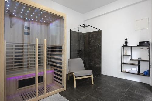 a room with a chair and a window with lights at Apartments Villa Mili in Brela