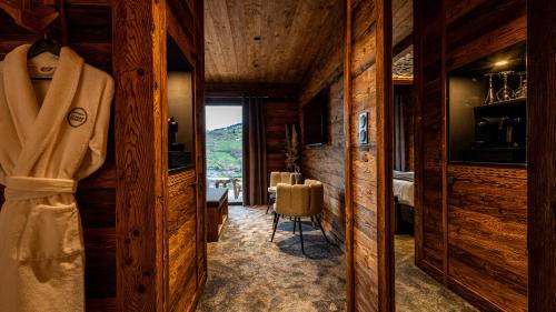 a room with wood paneling and a bedroom with a view at LA CABANE DU BREUIL in La Bresse