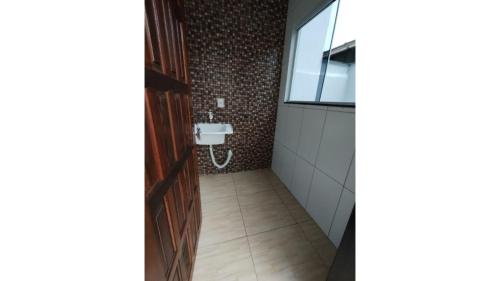 a bathroom with a sink and a toilet at Casaville in Joinville