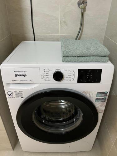 a washing machine with a towel on top of it at Jana apartment in Belgrade