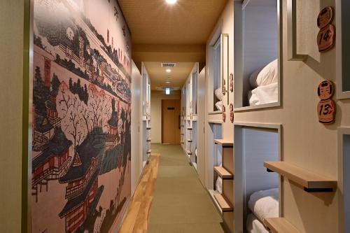 a hallway of a hospital with posters on the walls at Hotel Tomariya Ueno in Tokyo
