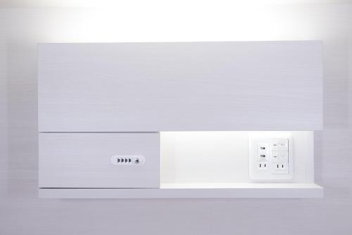 a white microwave oven sitting on top of a shelf at Hotel Tomariya Ueno in Tokyo
