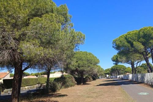 a street with trees on the side of a road at studio au cap d'agde dans les pinèdes in Cap d'Agde