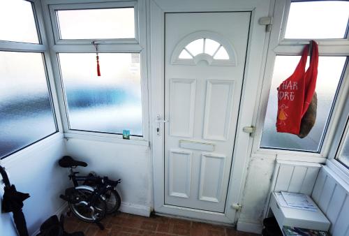 a room with a door and a bike in it at ANAND HOUSE in Harrow
