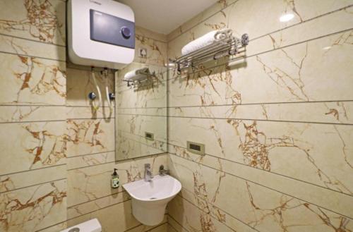 a bathroom with a sink and a mirror at Del Fox Hotel Shanti Residency At New Delhi Railway Station in New Delhi