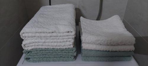 two stacks of towels on a shelf in a bathroom at Jana apartment in Belgrade