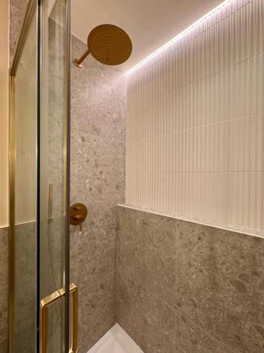 a shower with a glass door in a bathroom at Charmant loft intime in Croisy-sur-Eure
