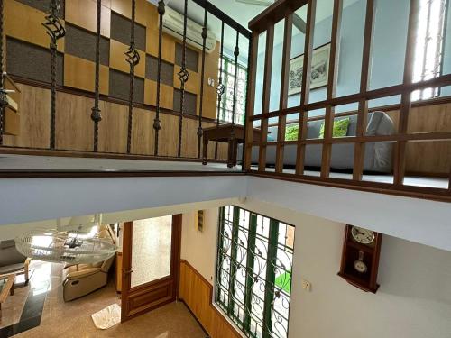 an overhead view of a room with a staircase with windows at Spacious BBQ Gathering Masai Megaria in Masai