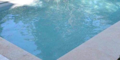 a swimming pool with blue water in it at Villa celine in Aliki