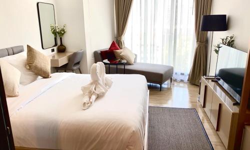a hotel room with a bed with a bow on it at Edge Central Pattaya, Luxury Place, High Speed internet in Pattaya Central
