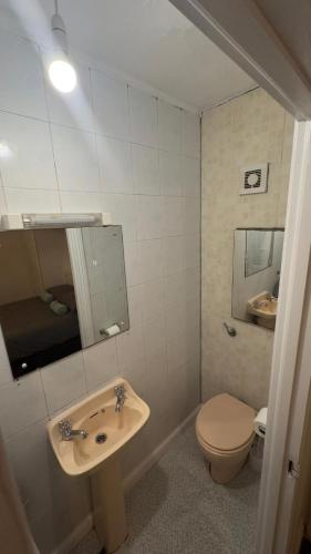 a bathroom with a sink and a toilet at En-Suite Room Clontarf House in Dublin
