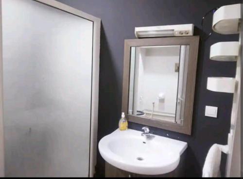 a bathroom with a sink and a mirror at Hydra Résidence Privée in Hydra