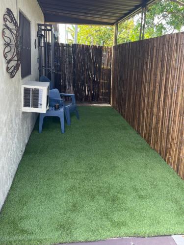 a backyard with a fence and green grass at cozy studio apartment with private entrance and patio in Miami