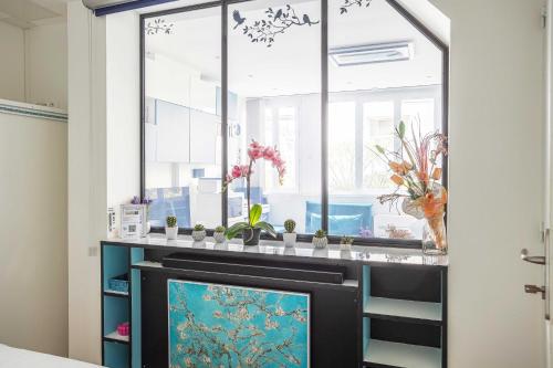 a room with a window and a fireplace at ParisMyHome - AIR COND, 2 SHOWERS, 2 WC in Paris