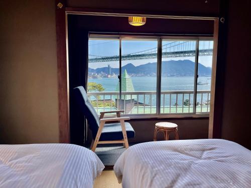 a bedroom with a window with a view of the water at 海峡別荘 in Shimonoseki
