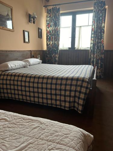 a bedroom with two beds and a window at Cowboys Guest Ranch in Voghera