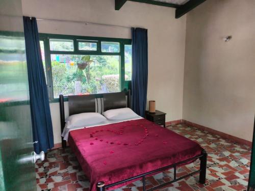 a bedroom with a bed with a large window at CQ SANTA ANA in San Antonio del Tequendama